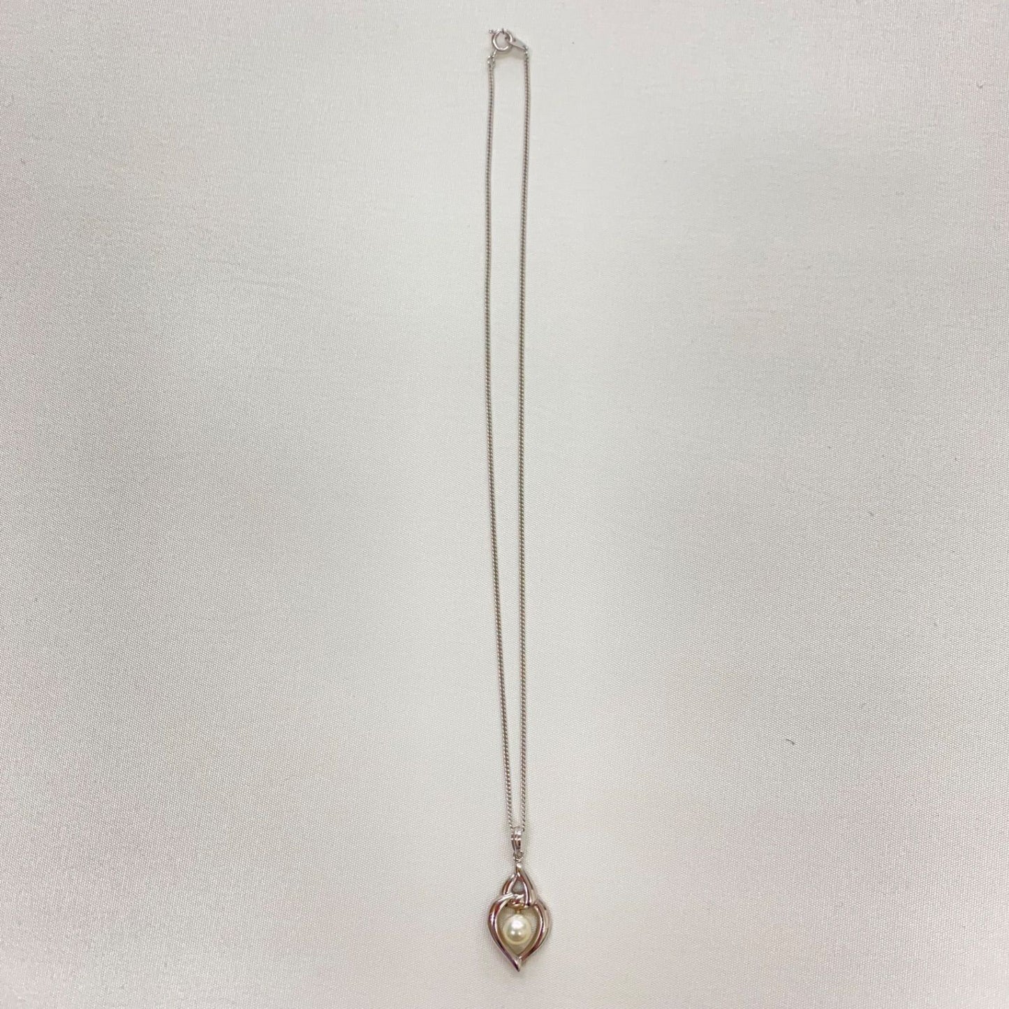 Mikimoto pearls necklace showing white pearls with slight cloudiness due to aging