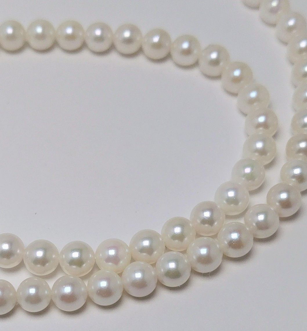 Akoya pearl necklace featuring round 5.5-6.0mm white, green, and pink pearls with good luster
