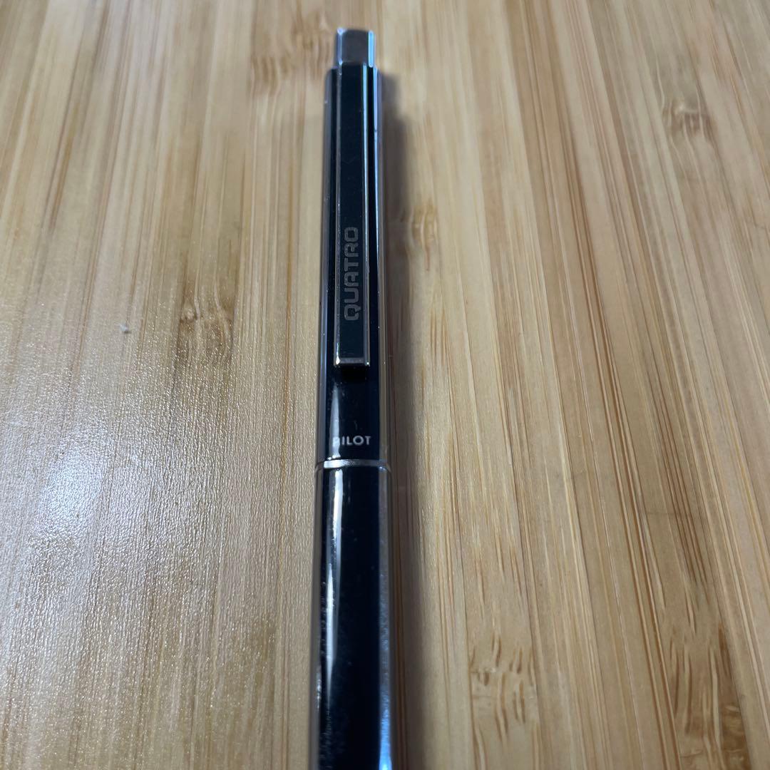 PILOT Quattro black ballpoint pen shown with cap and medium point tip