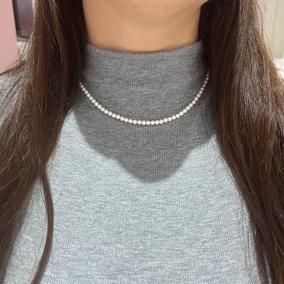 Close-up of Akoya pearl necklace featuring 4-4.5mm lustrous white pearls on a delicate strand