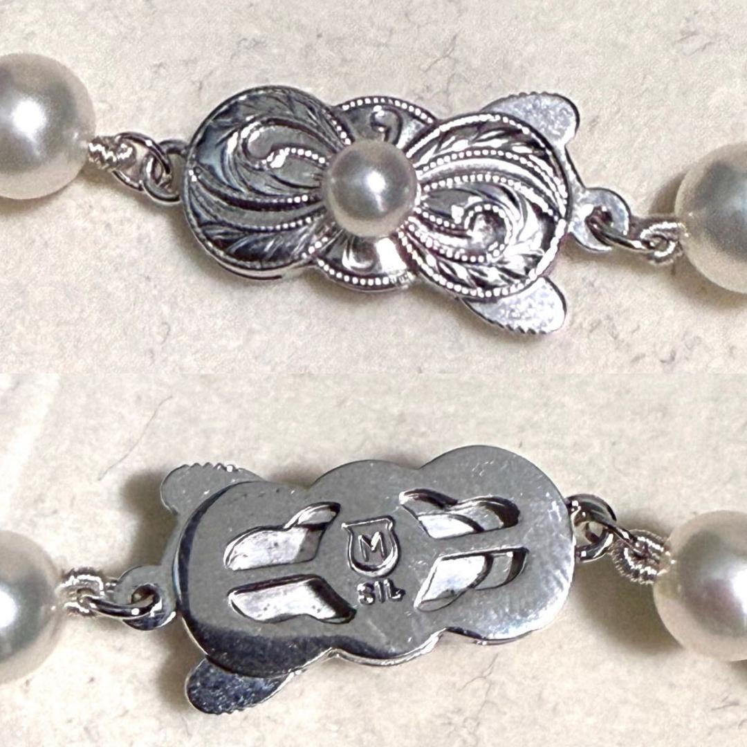 Mikimoto Akoya pearl necklace with 6.5mm pearls and silver clasp on a white background
