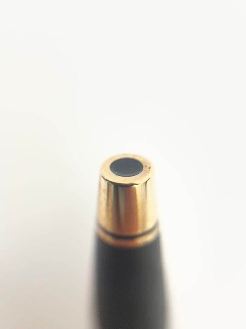 CROSS ballpoint pen body with matte black finish and gold trim on a white background