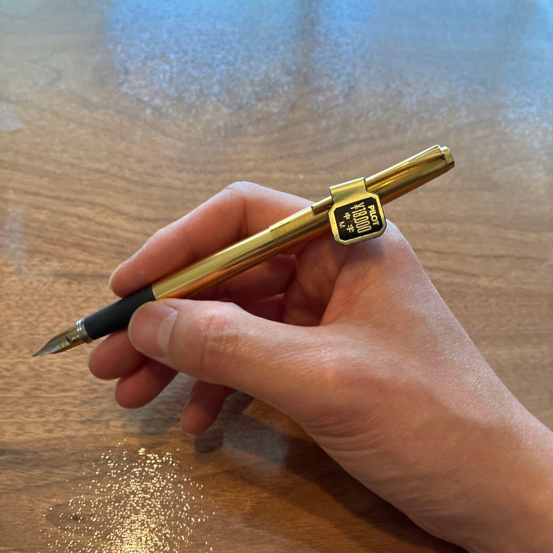 New PILOT fountain pen featuring an 18K gold nib with sleek black body and silver accents