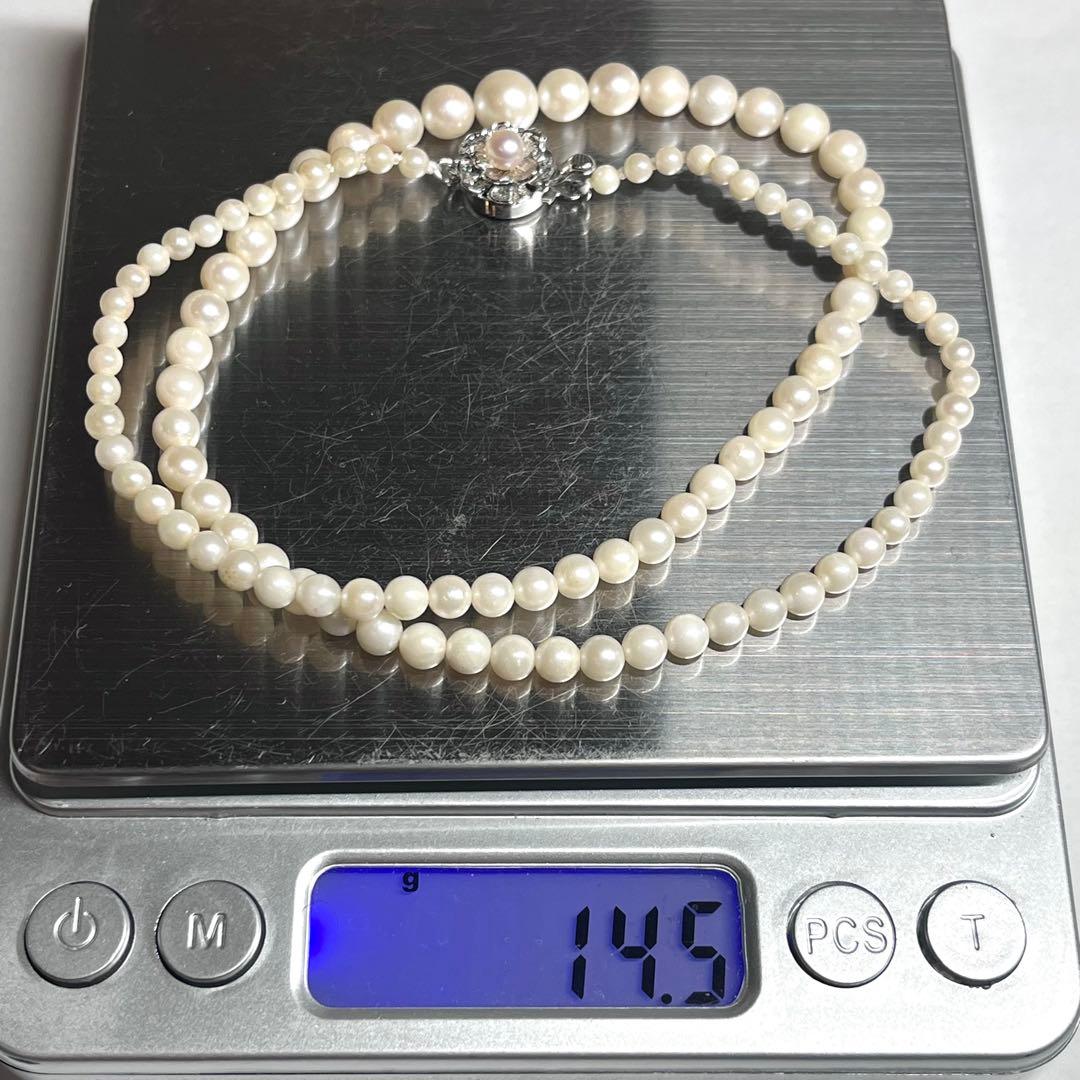 Aoya pearl necklace with cream baroque pearls and silver clasp on white background