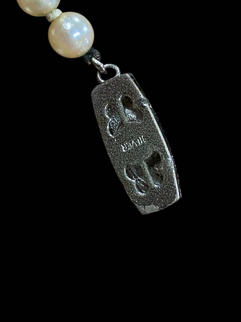Akoya pearl necklace featuring 5.1mm pearls with silver mark setting on a 41 cm chain