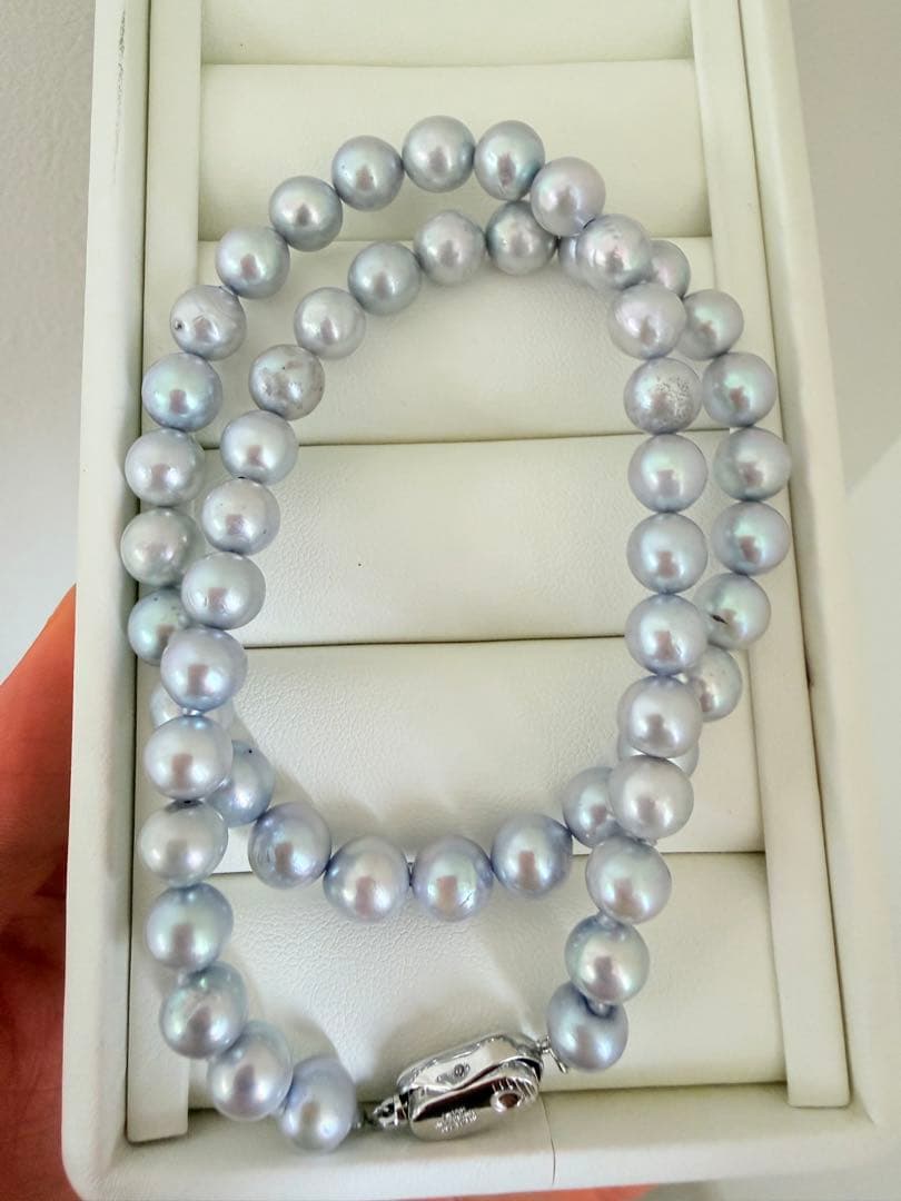 Akoya pearl necklace with 7-8mm ice blue gray semi-baroque pearls showing natural growth marks and gentle shine