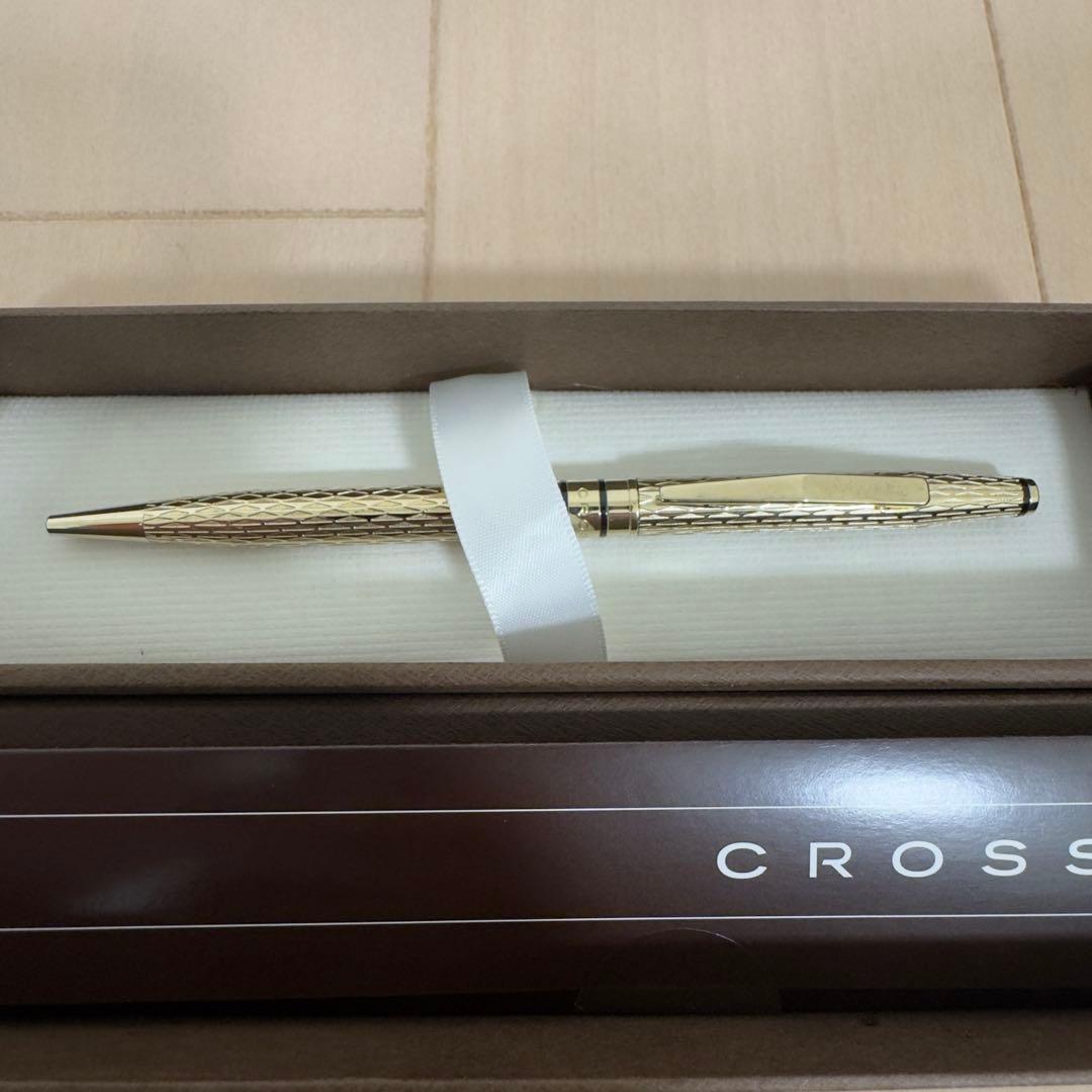 Gold CROSS ballpoint pen with diamond cut design displayed alongside original box