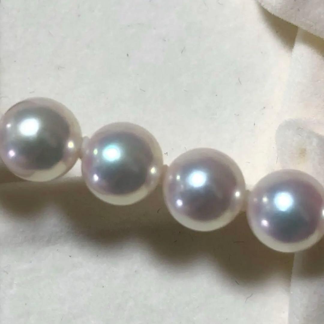 Akoya pearl necklace with 7mm white pearls and silver clasp laid flat showing length and bead size