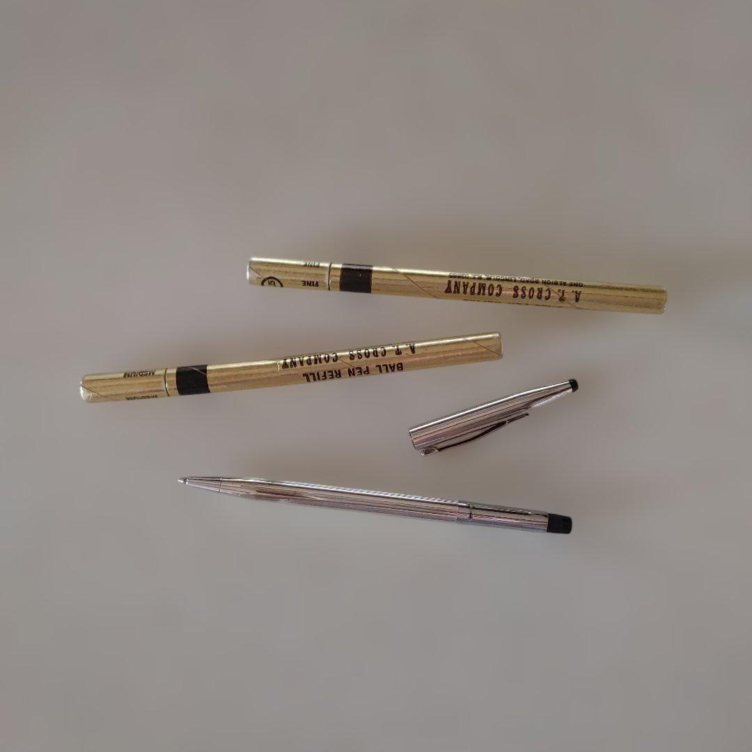 Cross silver ballpoint pen main body with two refill cartridges showing small dent