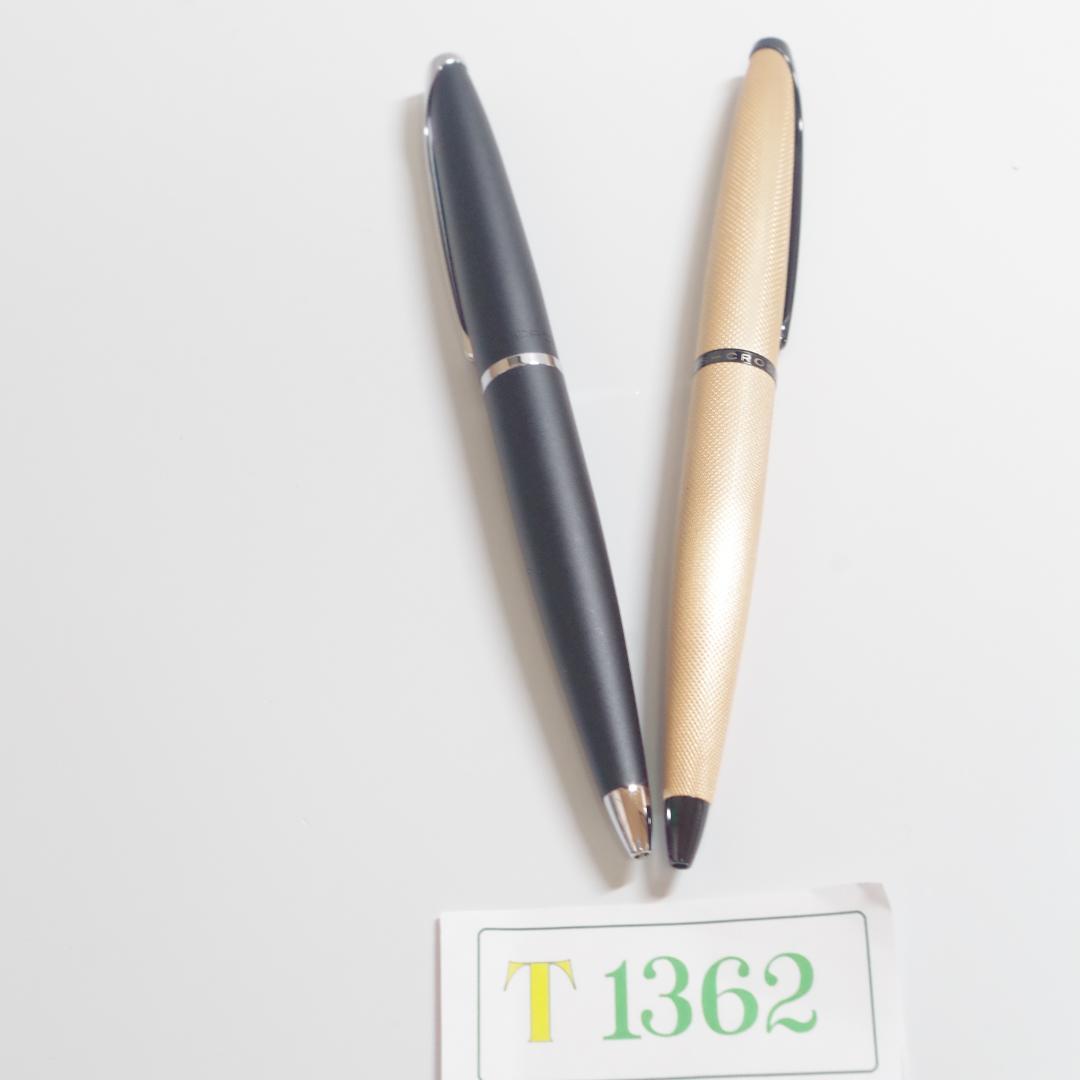 Two T1362 CROSS ATX ballpoint pens with worn surfaces and no ink, side by side on white background