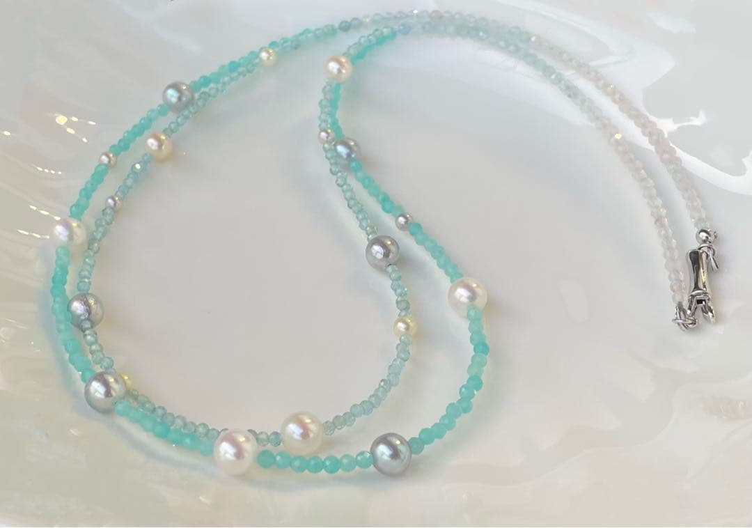 Akoya pearl layered necklace with 19 pearls in sea and sky colors showcasing transparency and unique design