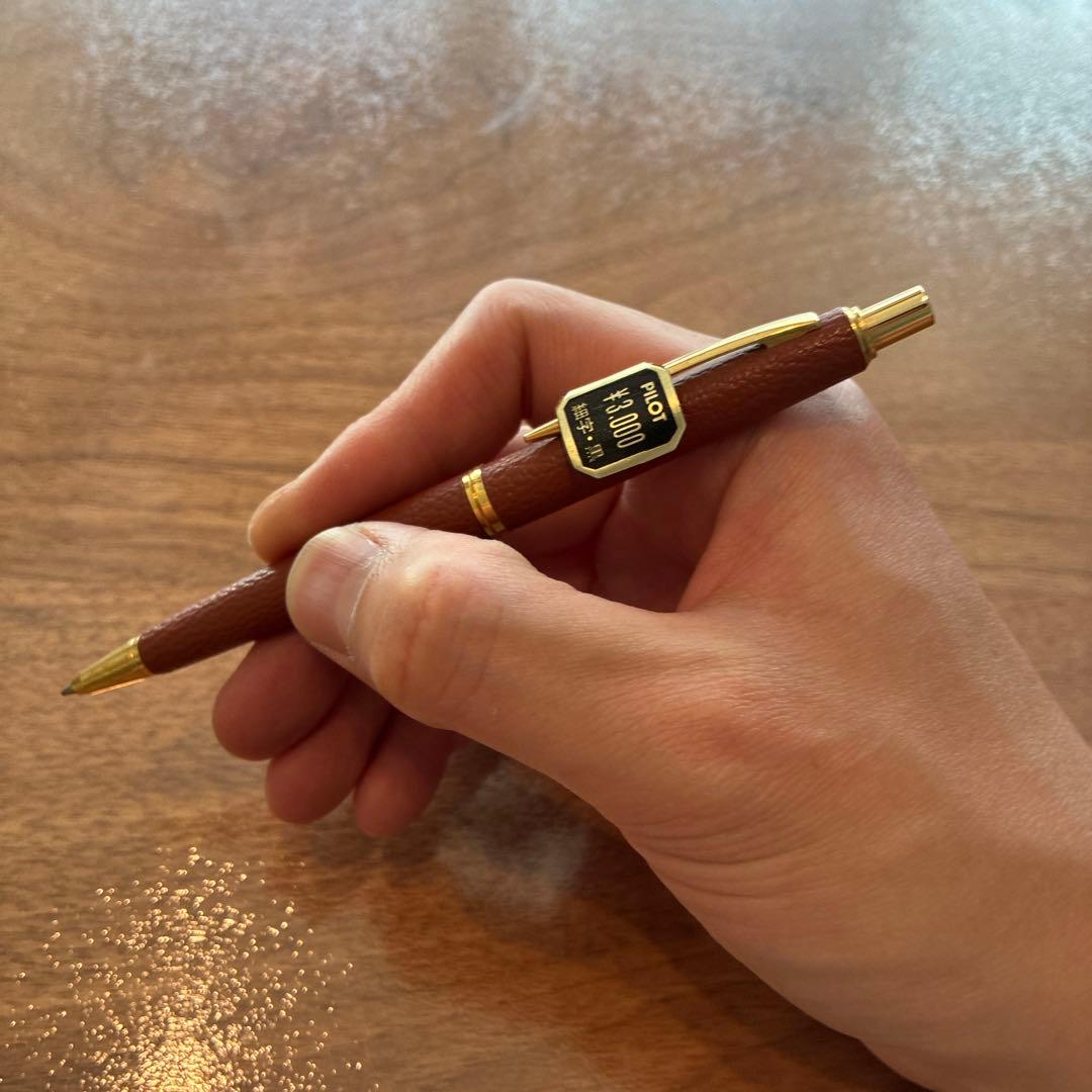 New PILOT high-end ballpoint pen with brown leather-like body and gold accents, fine point tip, black ink