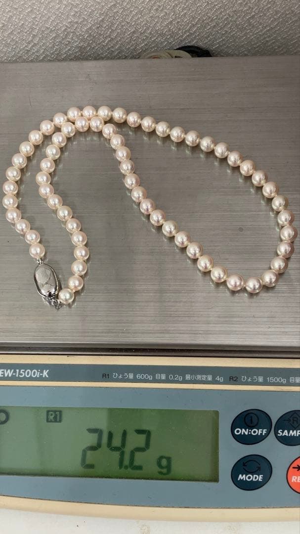 Akoya pearl necklace with approximately 6.7mm pearls and 43cm length on a white background