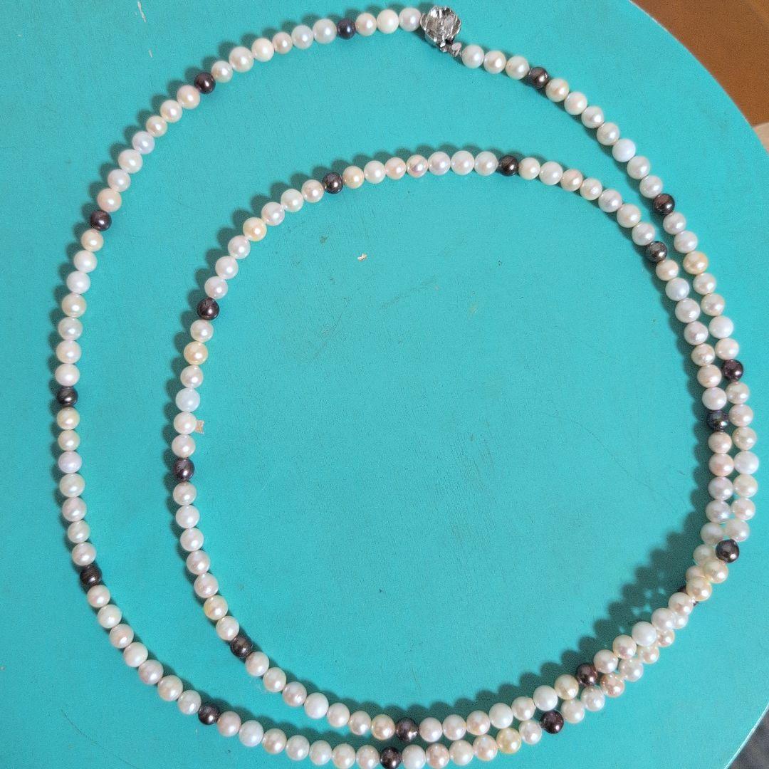 Akoya pearl long necklace with white and cream pearls sized 5.5 to 7 mm showing natural dents and wrinkles