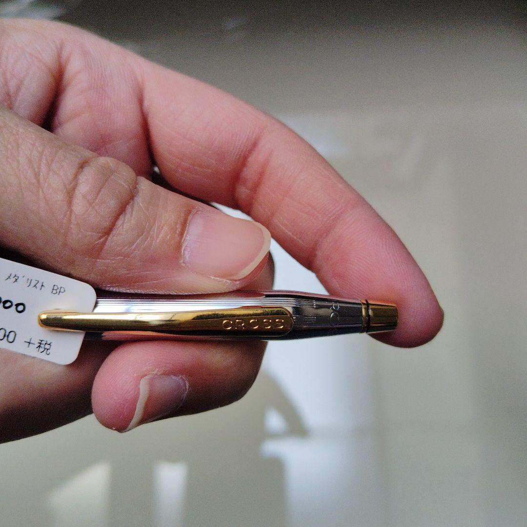 New CROSS Classic Century ballpoint pen with silver body and gold clip on white background
