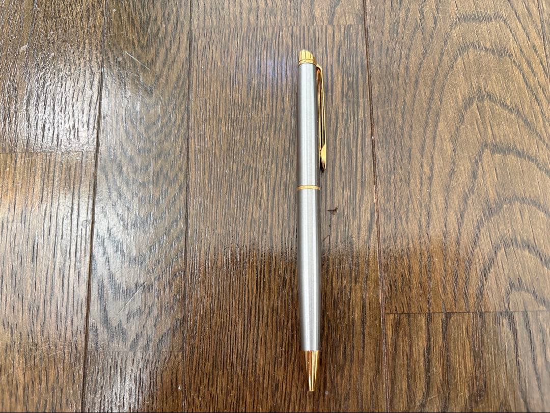 Waterman ballpoint pen in silver with gold metal parts and stripe design featuring a clip