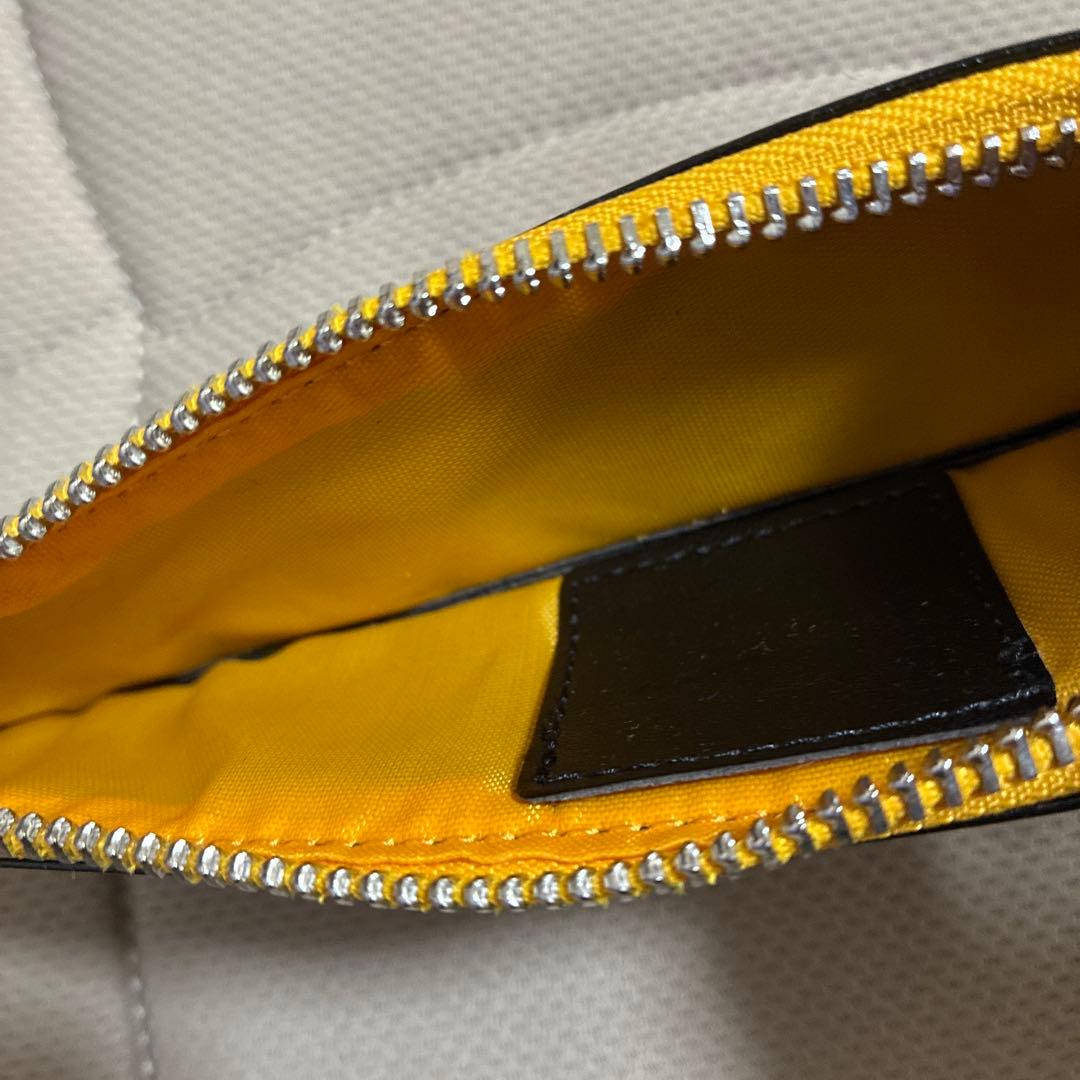 CROSS ballpoint pen in matte black with gold accents next to a yellow interior dedicated case