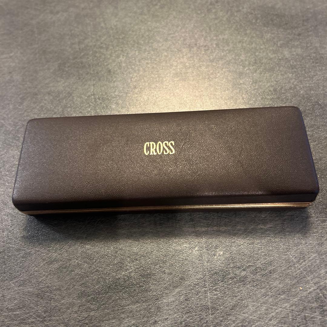 CROSS ballpoint pen with gold finish displayed alongside its matching gold dedicated case