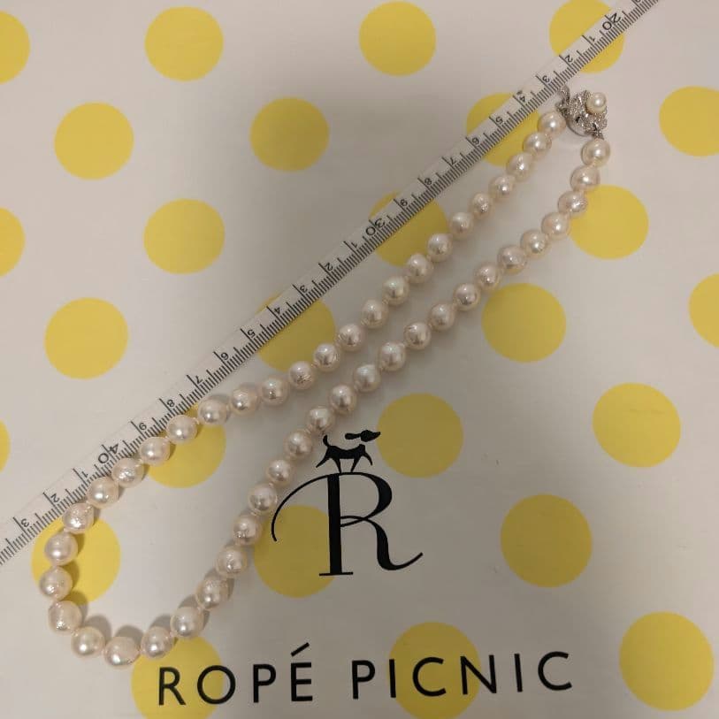 Close-up of Akoya pearl necklace featuring large 7mm semi baroque pearls on a delicate chain