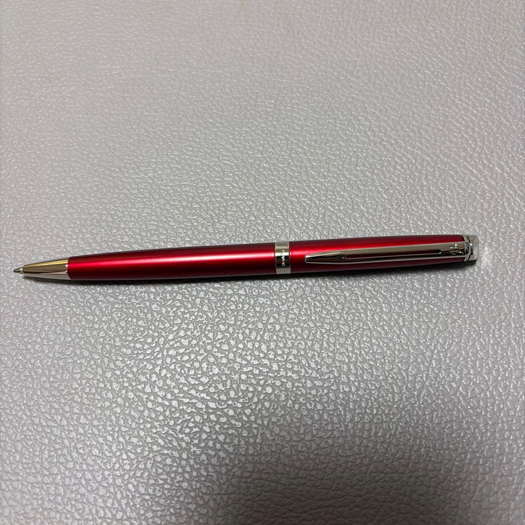 Red Waterman ballpoint pen stored in a pen case with sleek design