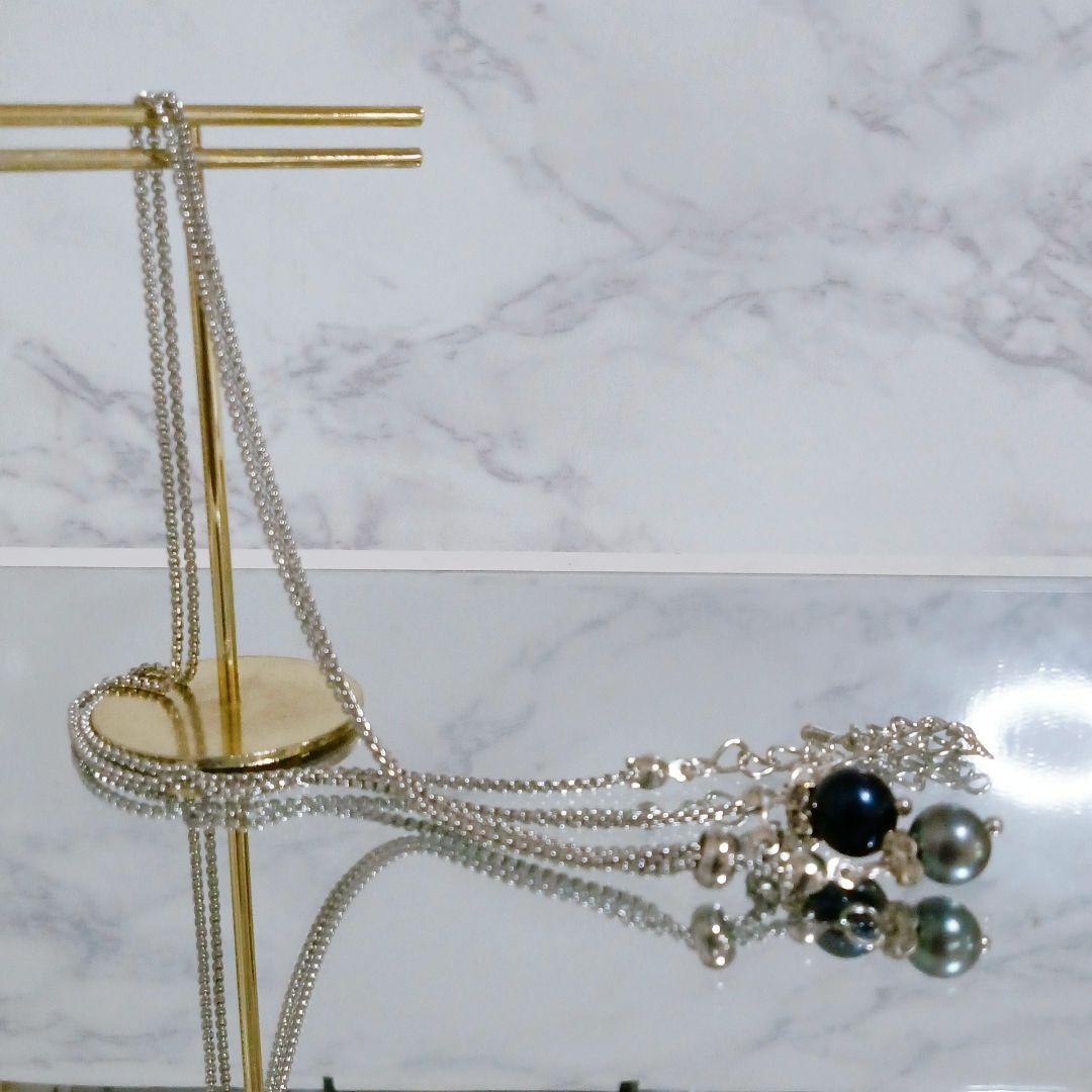 Akoya pearl necklace with slightly round pearls and silver nickel-free clasp on white background