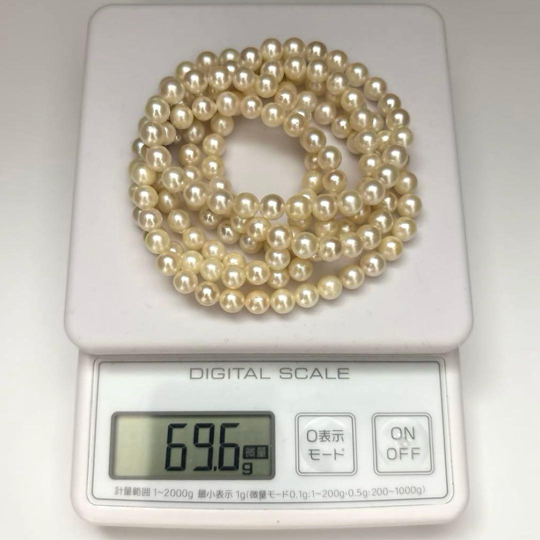 Long Akoya pearl necklace, 108cm length, 7mm pearls, 2-strand design, white pearls on a jewelry display