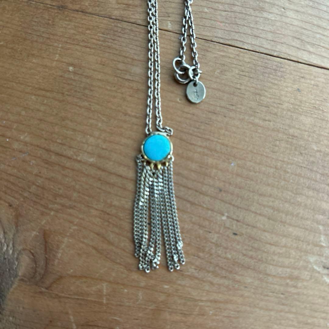 Agot Turquoise silver pendant with round cut stone and gold tone multiple hanging chains in tassel design