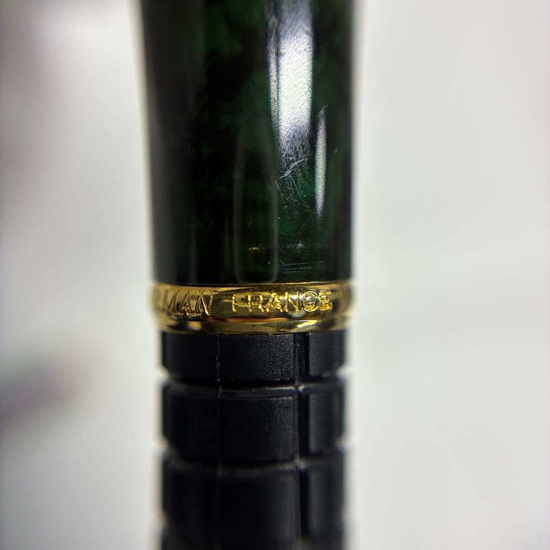 Waterman Exclusive Ballpoint Pen with green marble body, gold trim, and black textured grip