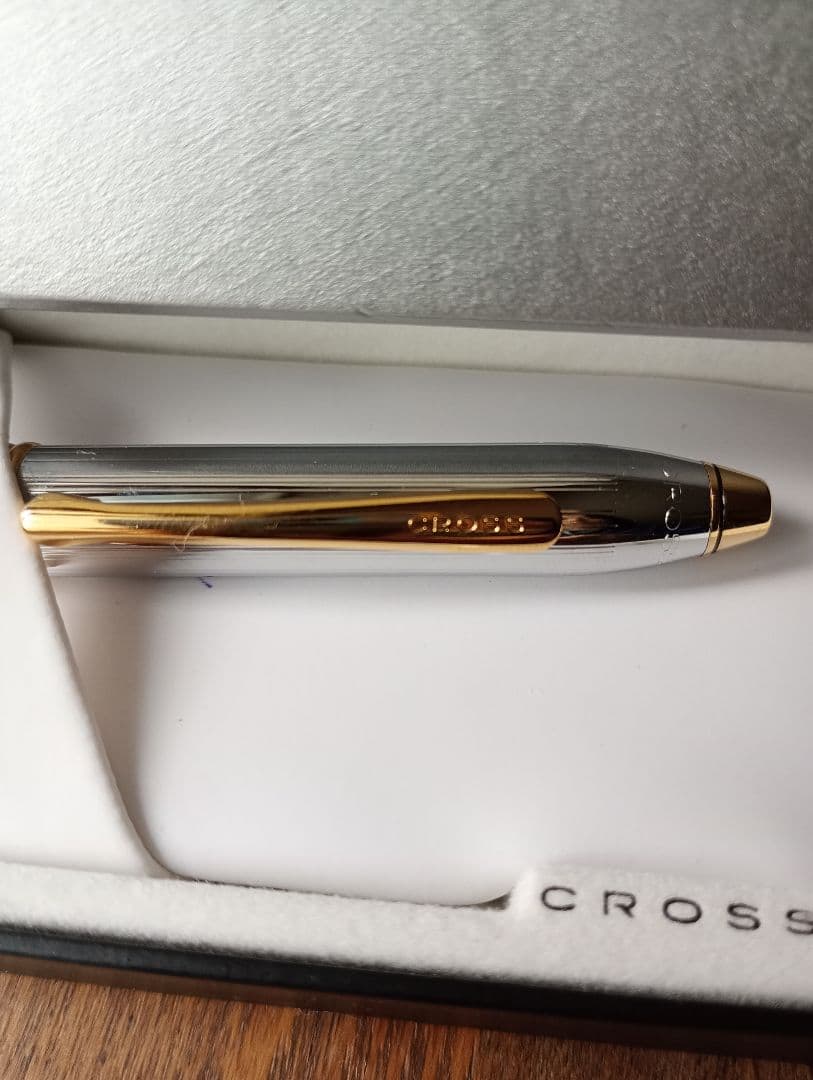 Slightly used Cross ballpoint pen with black ink and engraved alphabet name showing minor scratches and dirty box