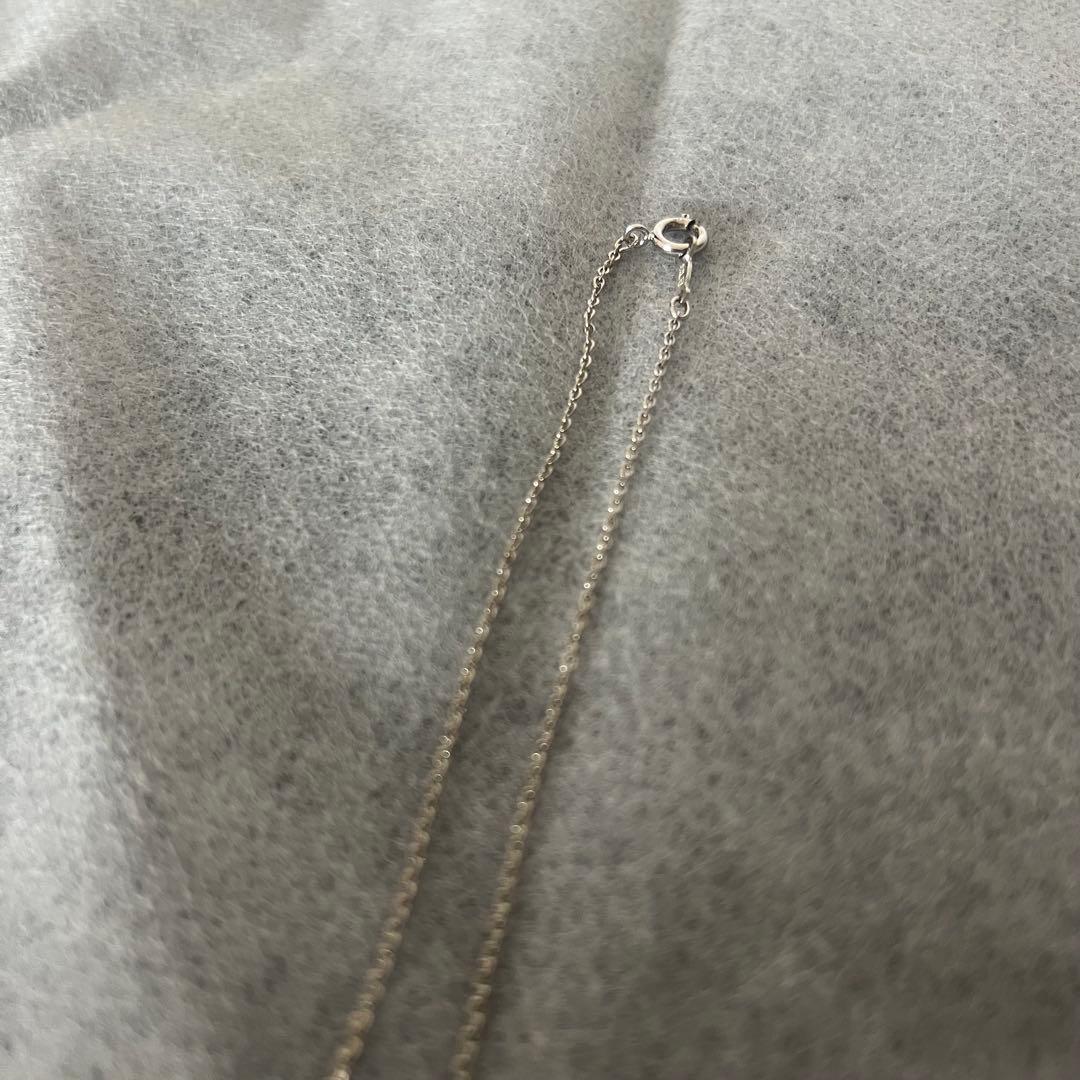 Mikimoto Akoya pearl necklace pendant with four pearls on a 40 cm silver chain, displayed on a white background