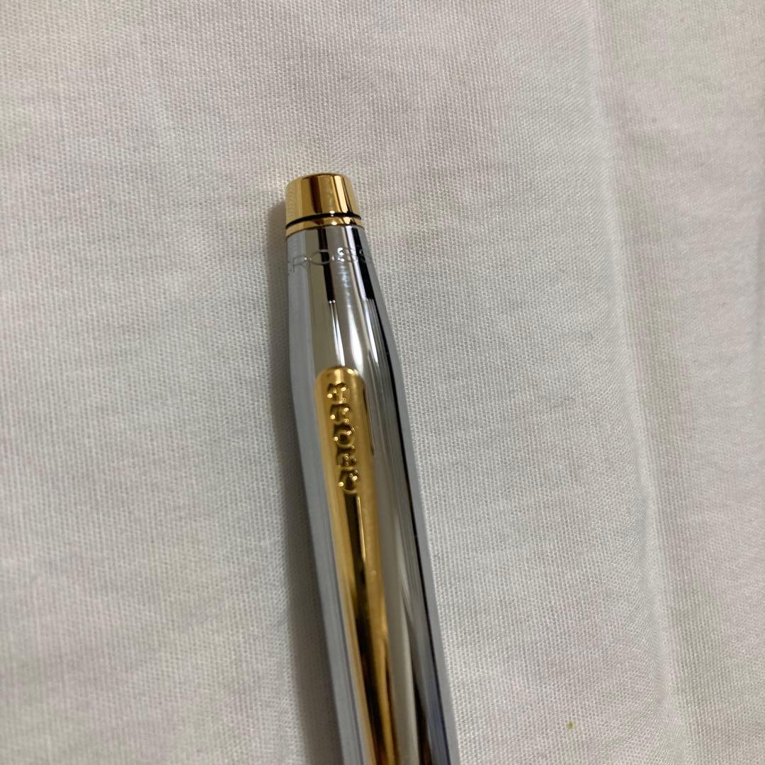 New Cross ballpoint pen in black with silver accents, shown uncapped and ready to write