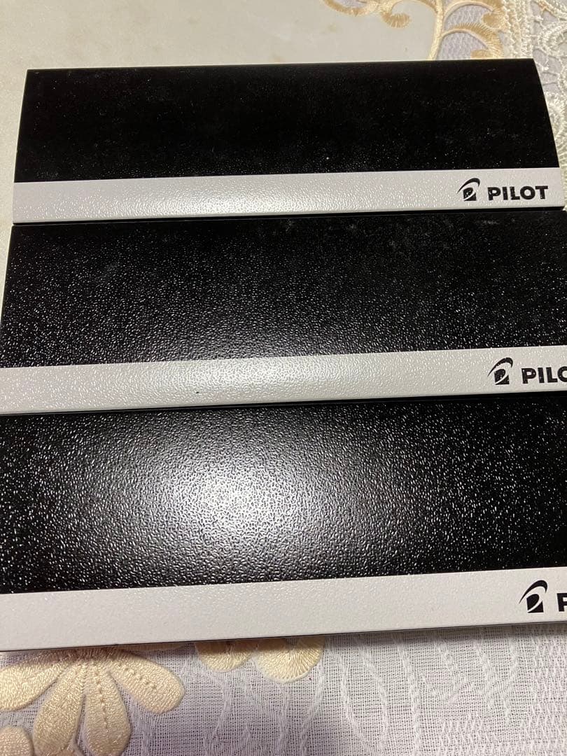 Set of three Pilot ballpoint pens in black, red, and blue with a black carrying case