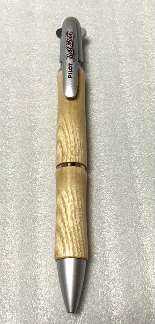 PILOT JustMeet wooden multi-function pen with three colors and mechanical pencil on a white background