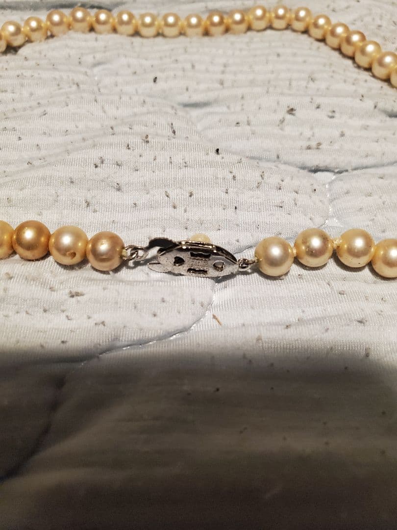 MIKIMOTO pearl necklace featuring round pearls and a pearl decorated clasp