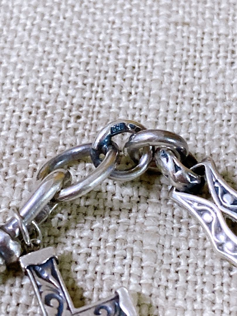 Agete Silver 925 bracelet featuring a cross motif and a pendant top on a white background