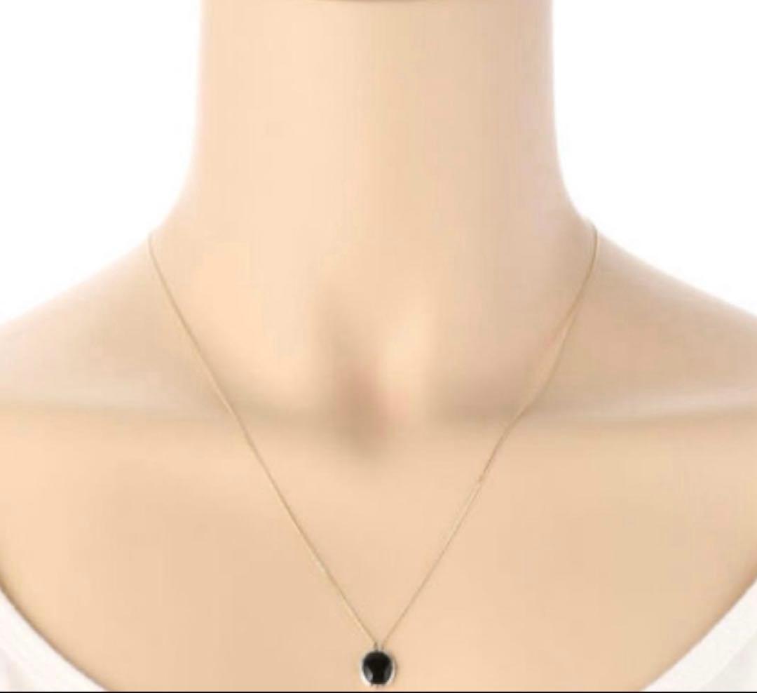 Agete K10 gold and silver necklace with small pendant and adjustable chain laid flat