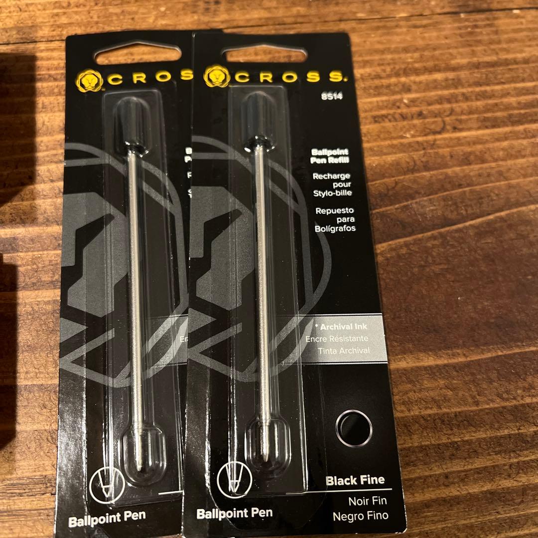 Two unused Cross ballpoint pen replacement refills without packaging on a white background