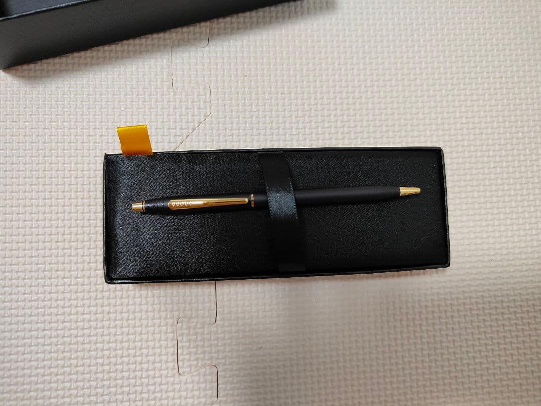 Cross black ballpoint pen with gold fittings shown on white background