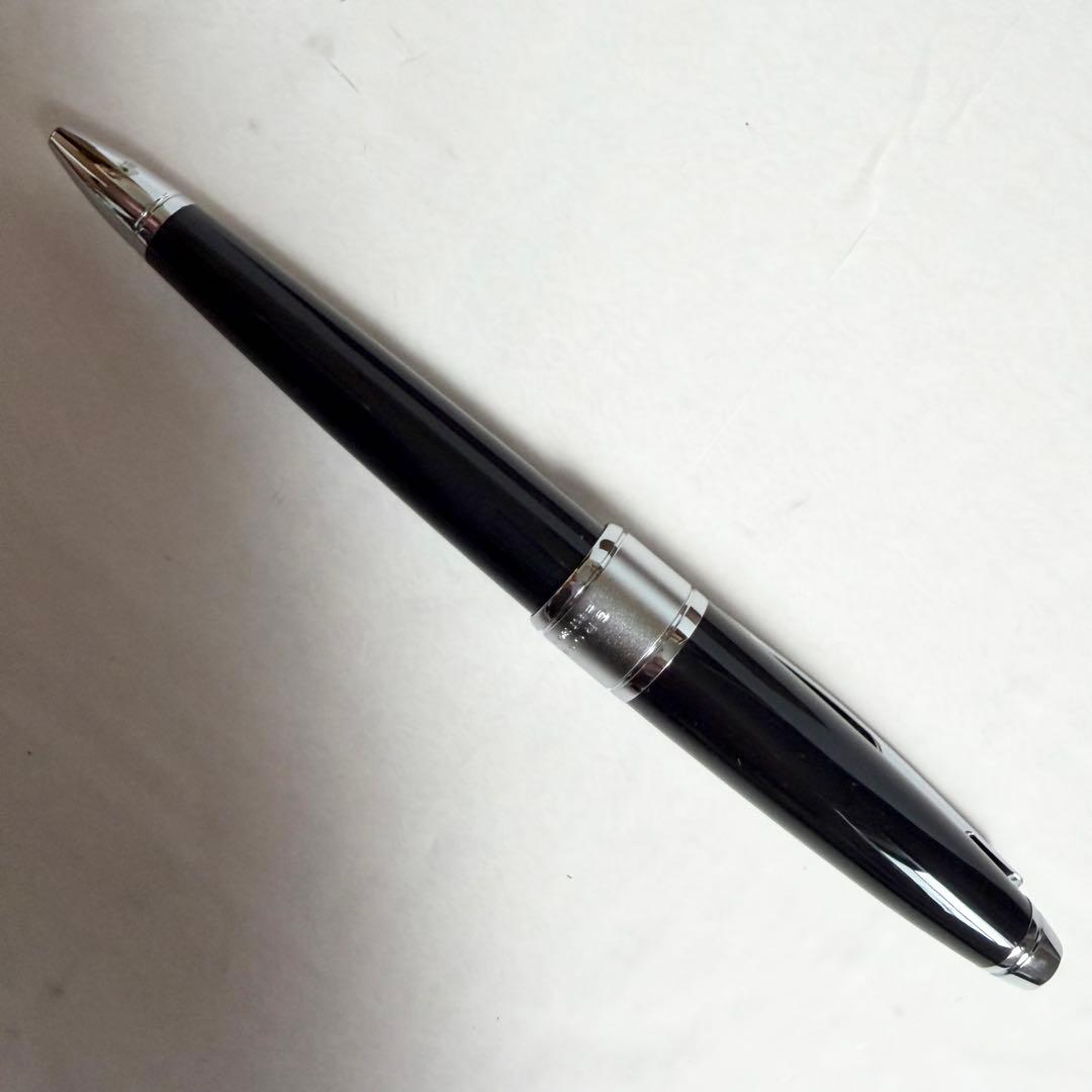 CROSS black ballpoint pen with chrome trim placed beside its dedicated metal case