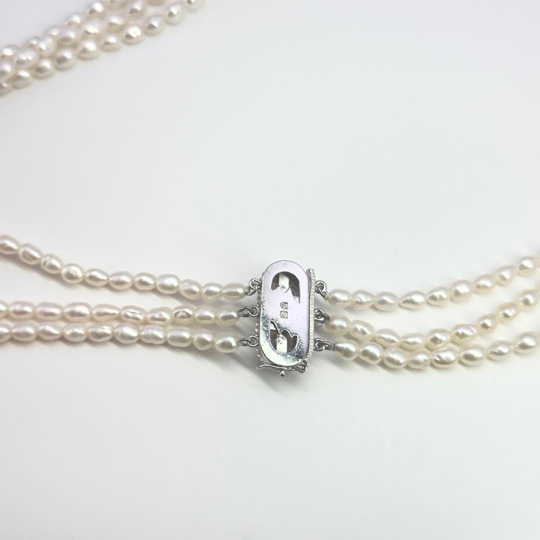 Tasaki SV Baroque Pearl triple strand necklace approximately 55cm long displayed on white background