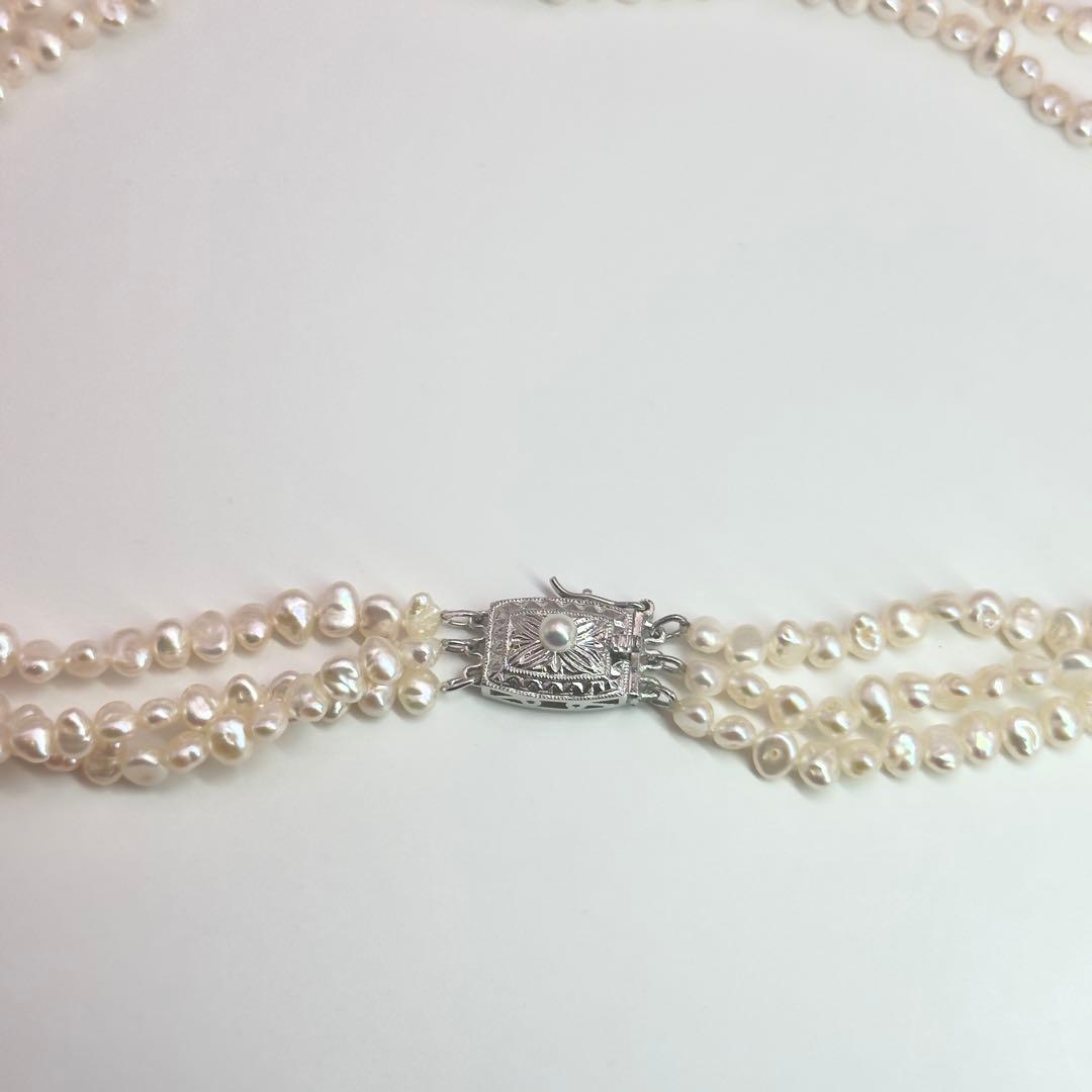 Tasaki Baroque Pearl three-strand necklace about 80cm long displayed on a white background