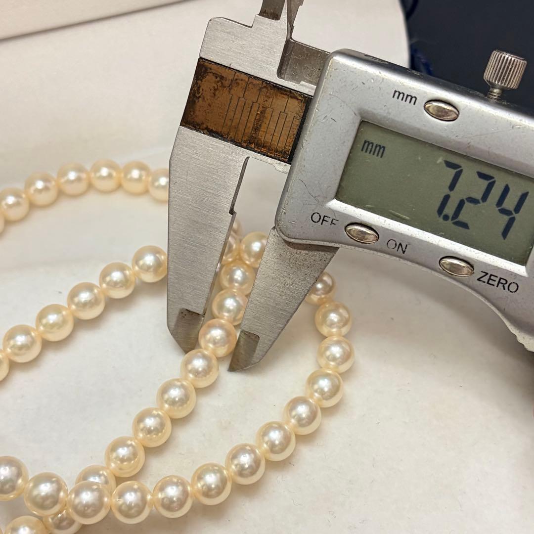 Akoya pearl necklace with 7.24mm white pearls and silver clasp on a white background