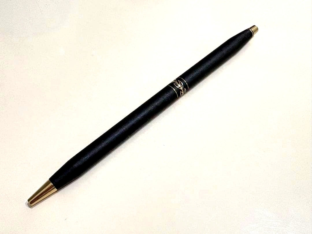 CROSS black ballpoint pen with gold leaf pattern ring and twist mechanism shown on white background