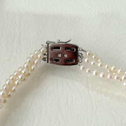 428 Tasaki silver necklace with three rows of approximately 2.7-2.9mm pearls and silver clasp