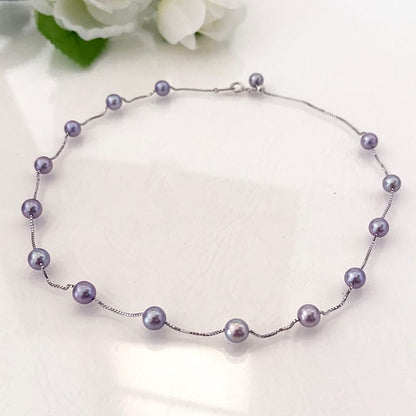186Tasaki K18 station necklace with purple pearls, 44cm adjustable chain on white background
