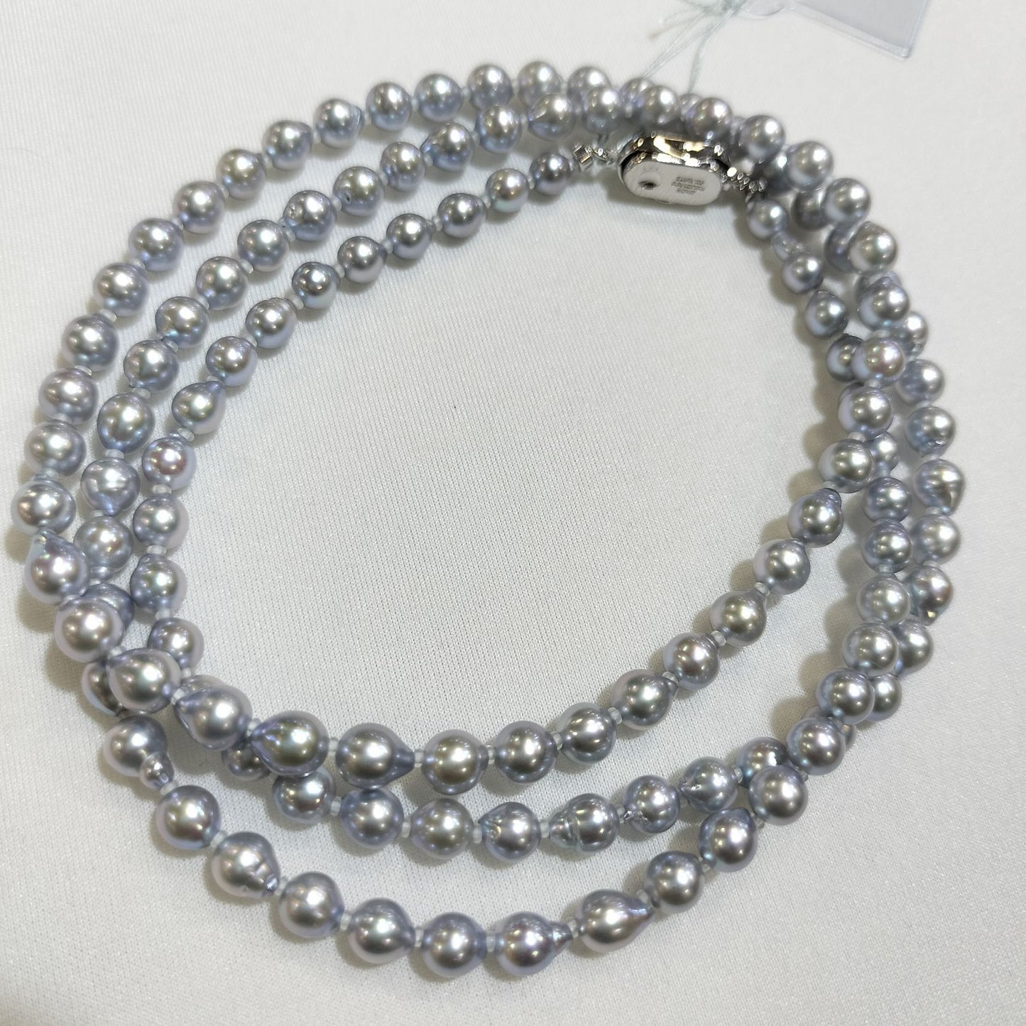 Akoya pearl treatment necklace featuring 5mm pearls and 80cm length on a white background