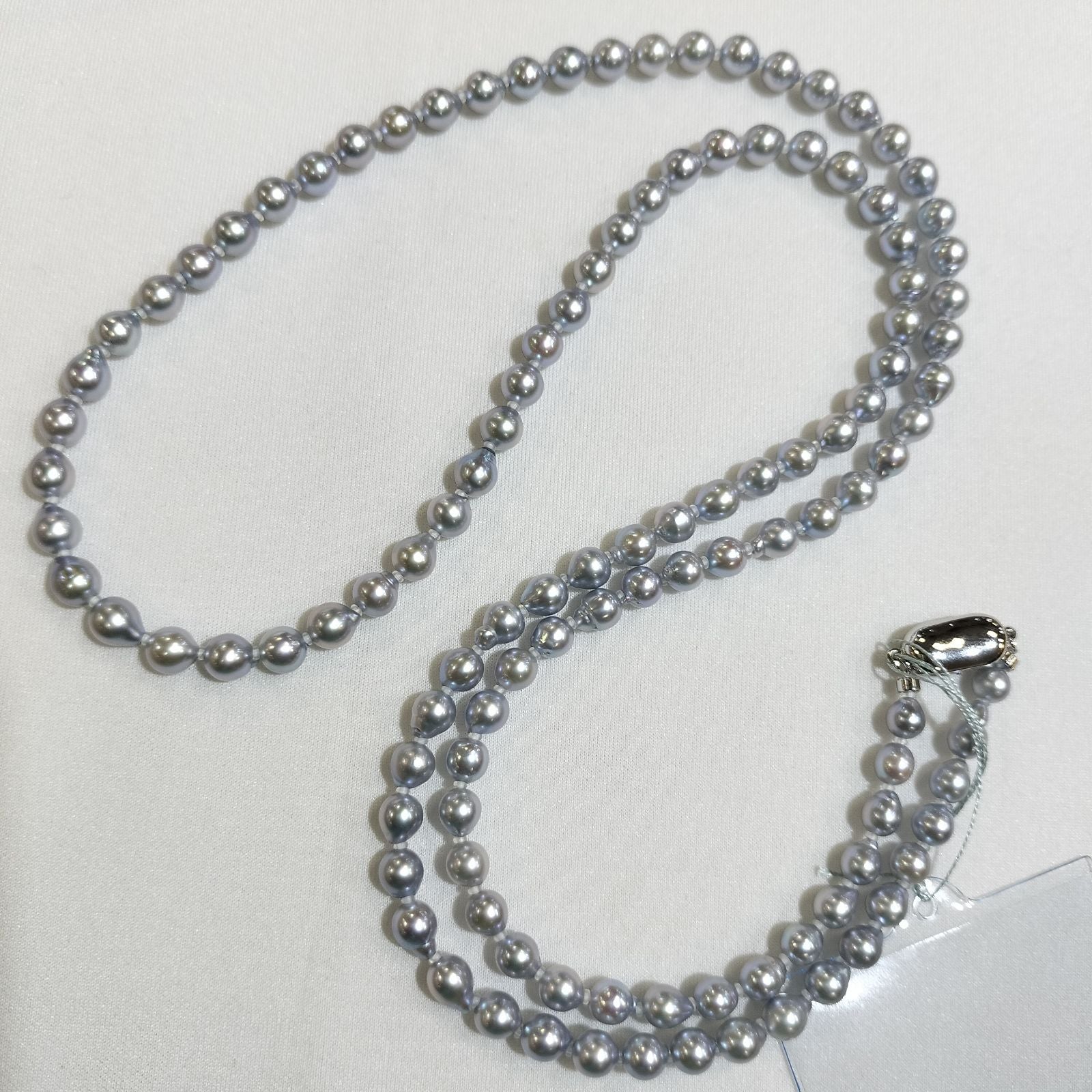 Akoya pearl treatment necklace featuring 5mm pearls and 80cm length on a white background