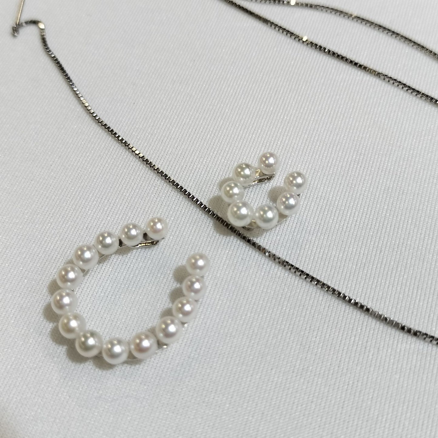 Akwoya Pearl Horseshoe Pendant Necklace with two horseshoe charms and small pearls on a 50cm chain