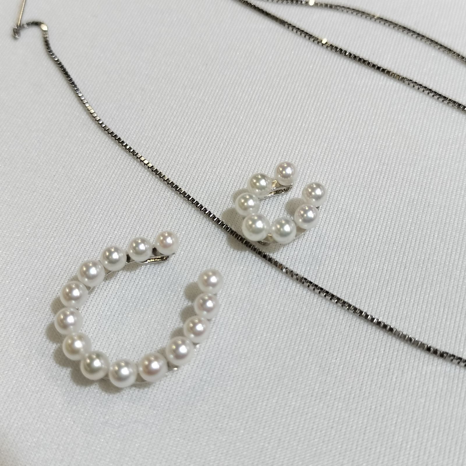 Akwoya Pearl Horseshoe Pendant Necklace with two horseshoe charms and small pearls on a 50cm chain
