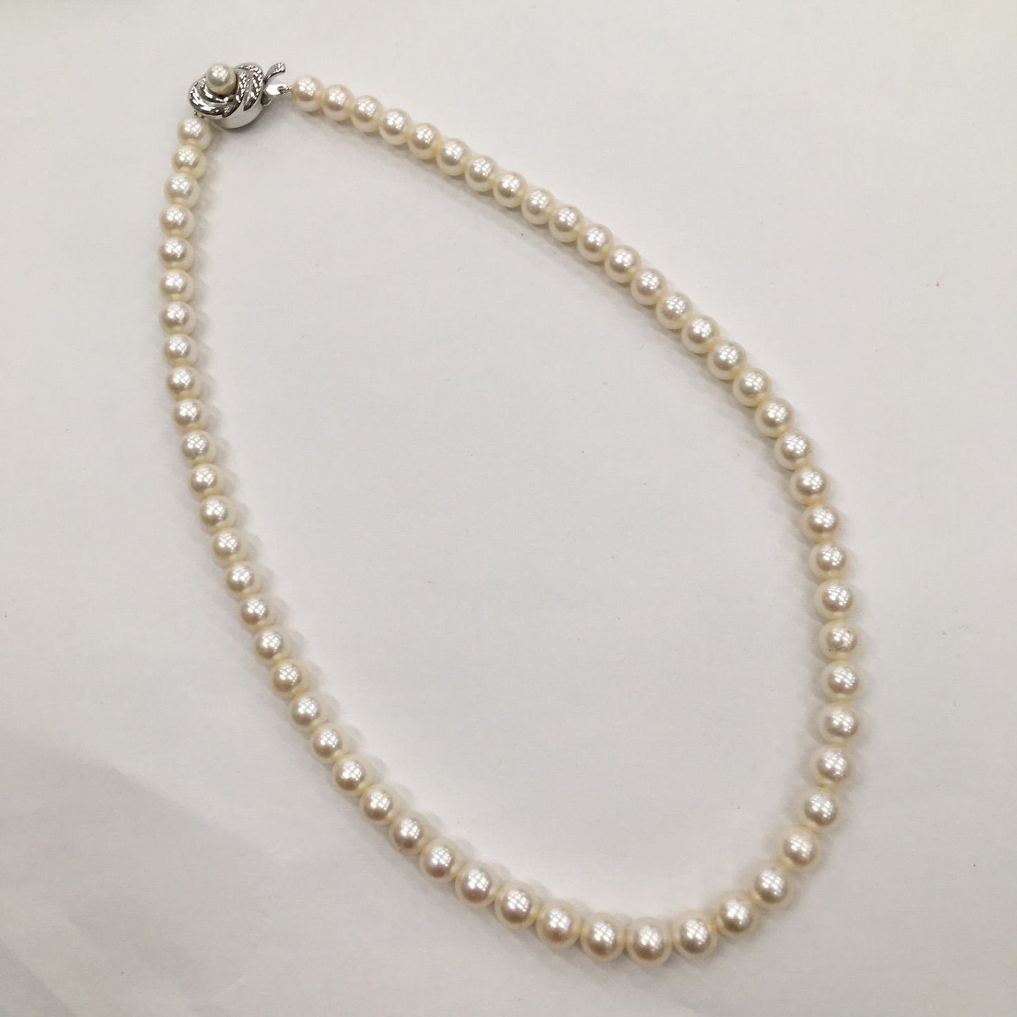 Tasaki Pearl Necklace featuring 7mm pearls in 19cm and 38cm lengths on display